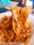 shrimp in a frying pan coated in butter garlic and parmesan cheese.