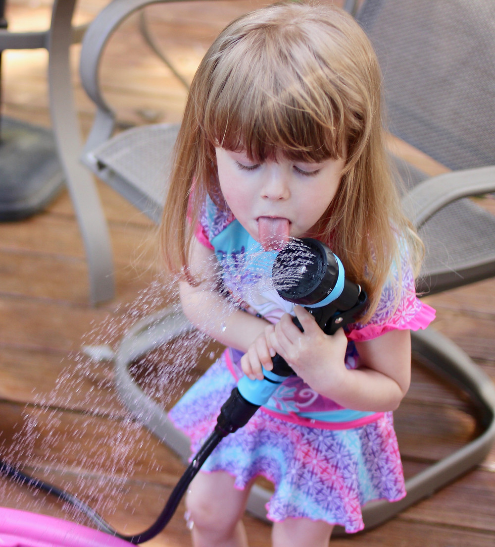 toddler playing in water