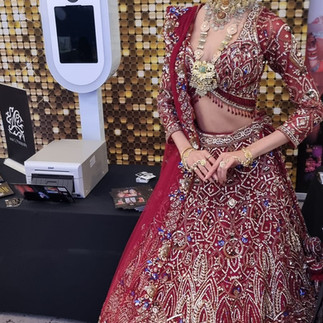 indian bride with the selfi photobooth with gold backdrop