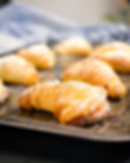 Gluten free sfogliatelle made from gluten free filo pastry on a metal baking tray.