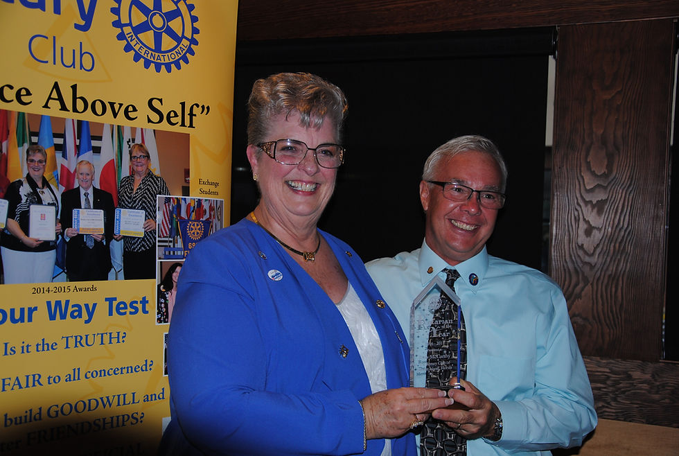 President Pat Tash presents President Elect Russ McCarthy with the "Rotarian of the Year" Award at the 2017 Board Installation Ceremony.
