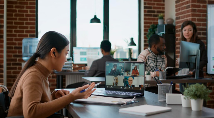 Business team collaborating remotely with virtual assistants using laptops and digital tools to improve operational efficiency in 2026.