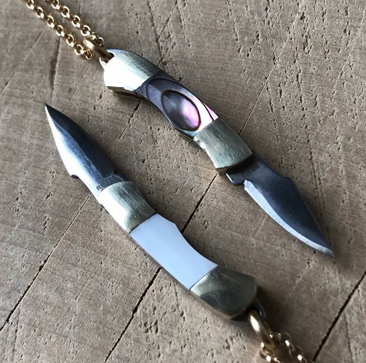 Thumbnail: Worlds tiniest working knife necklace