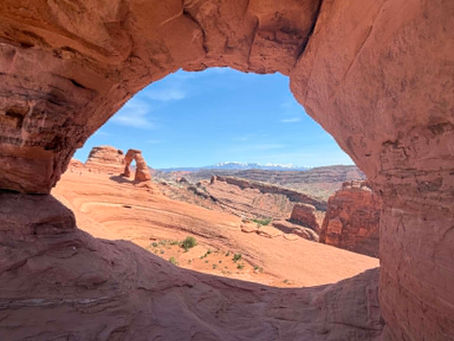 a view of Delicate Arch in Arches National Park, while looking through a different arch
