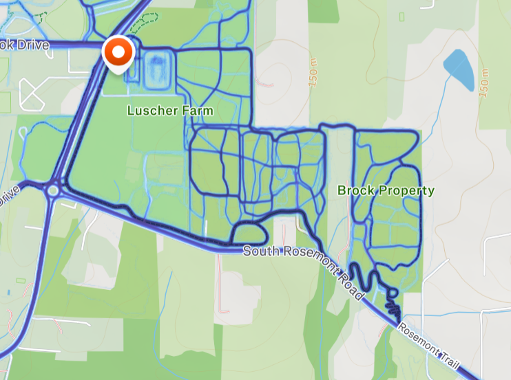 Map showing a blue route loop with an orange pin near Luscher Farm and Brock Property, along South Rosemont Road.