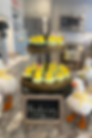 Yellow duckling cupcakes surrounded by faux, decorative white ducks