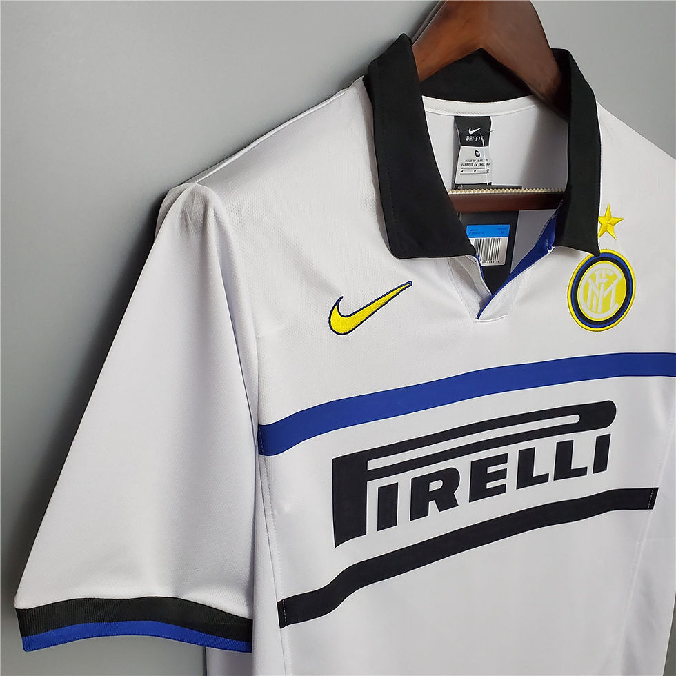 Thumbnail: White football shirt with black collar, yellow Nike logo and Pirelli text on it.
