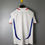 Thumbnail: White football jersey with blue and red details hanging from a hanger.