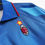 Thumbnail: Close up of the blue sports shirt with text and logo detail