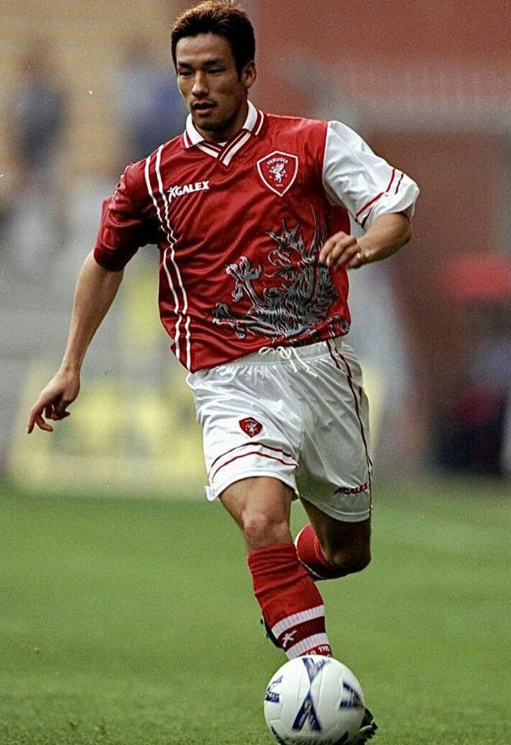 Thumbnail: Football player in red and white kit, running on the field Nostalgia Retro Kit