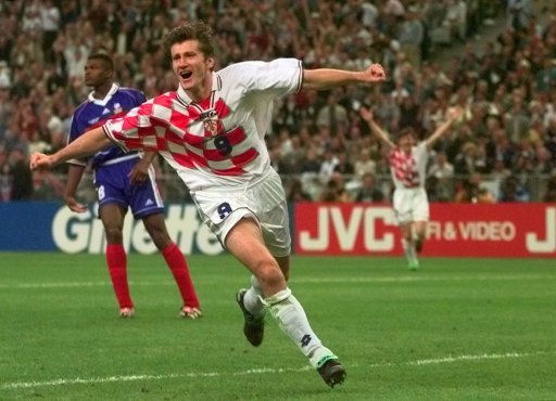 Thumbnail: Croatian player celebrates a goal, in front of a crowd, wearing white kit.