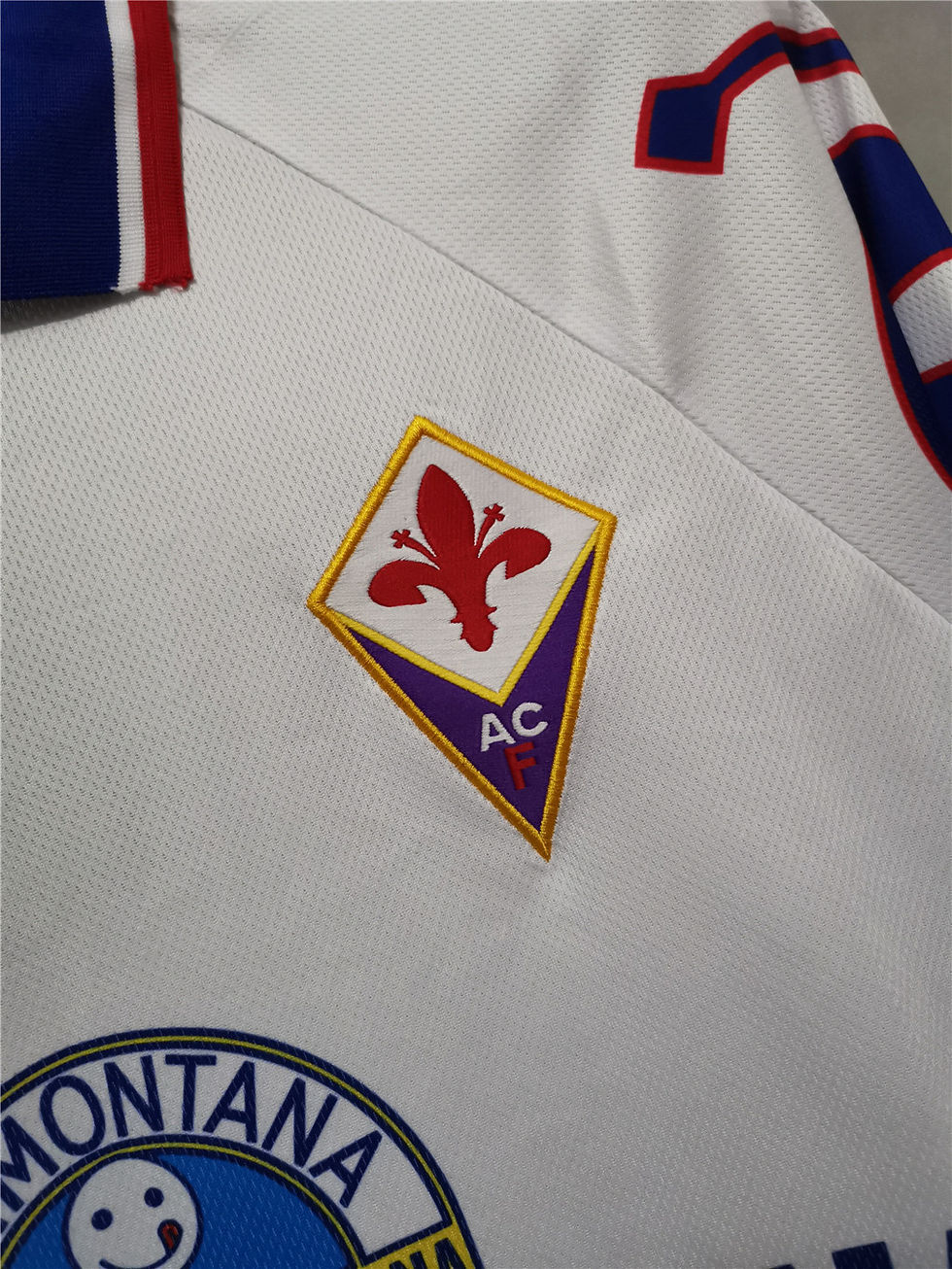 Thumbnail: Fiorentina football jersey with the team's logo and emblem on display.
