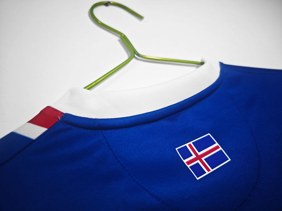 Thumbnail: Icelandic blue soccer jersey hanging on a green hanger. Nostalgia Retro Kit