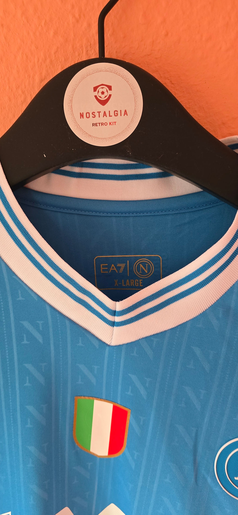 Thumbnail: Blue football shirt with EA7 brand and white stripes on the collar