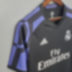 Close-up of a black football jersey with the Adidas logo, and Fly Emirates text.