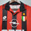 Thumbnail: Close up of a red and black striped soccer jersey with logos