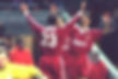 Liverpool players celebrate after scoring a goal; Fowler number 23 jersey; retro kit.