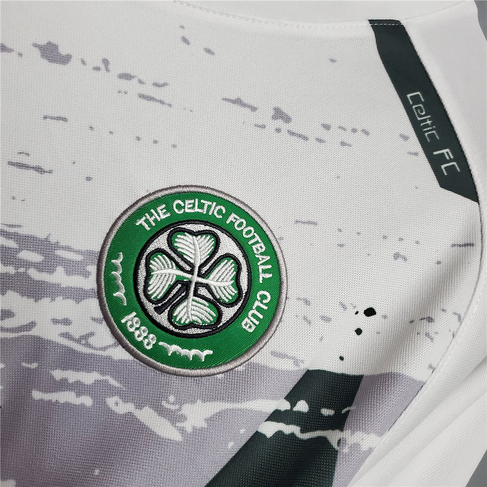 Thumbnail: Celtic Football Club logo on white jersey with green and gray details.