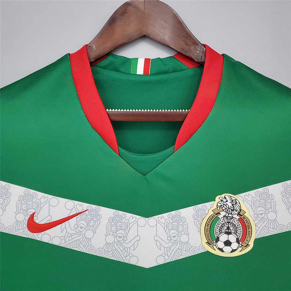 Thumbnail: Close up of Mexico's green football kit with Nike logo and crest