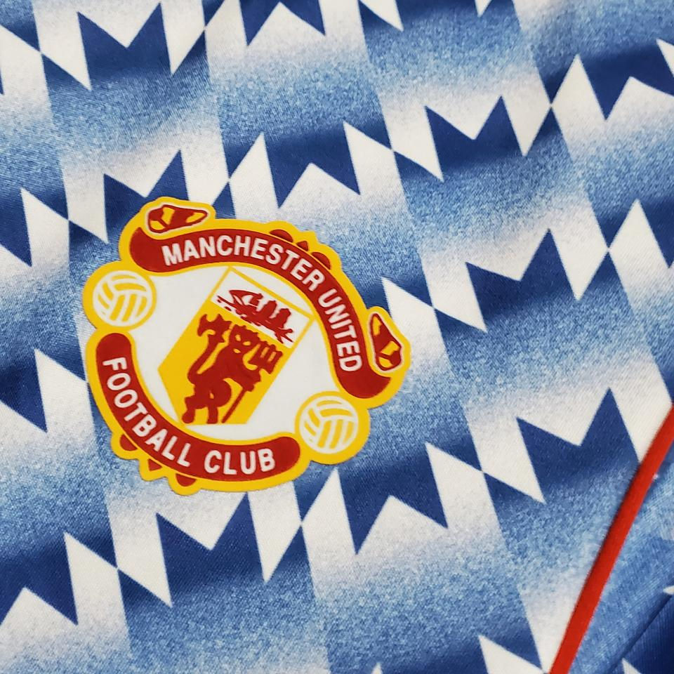 Thumbnail: Manchester United Football Club logo on blue pattern, nostalgic retro kit