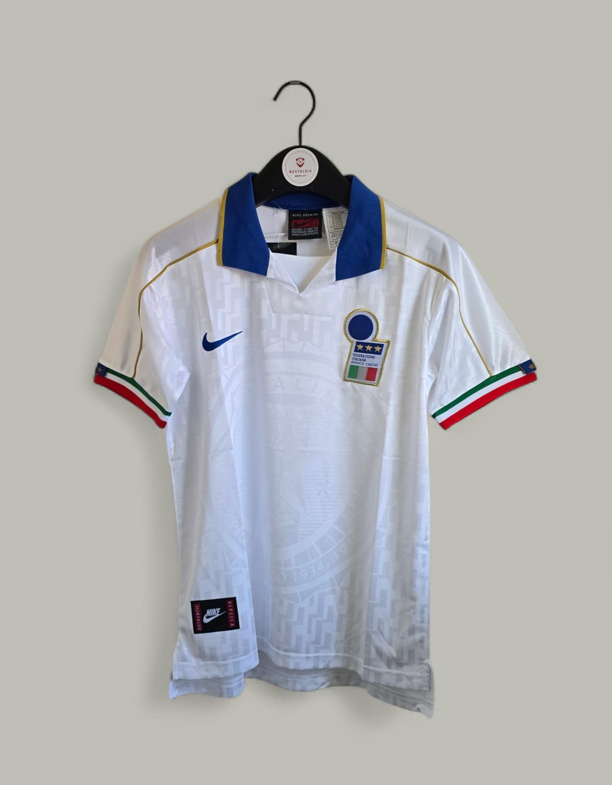 White Italy football shirt with Nike logo, 1995 ITALY AWAY WHITE RETRO FOOTBALL KIT, hanging on a wall
