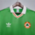 Green Adidas Ireland football jersey with white collar and logo, retro kit.