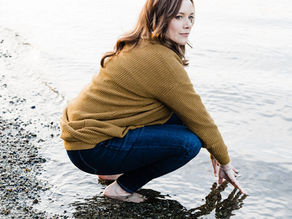 Woman crouching by water