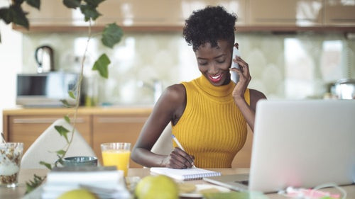 Black woman at her desk working.