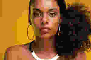Black healthy woman with a side ponytail.