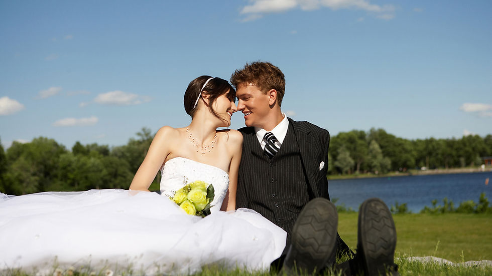 Wedding couple sit next to a lake in Vail Colorado