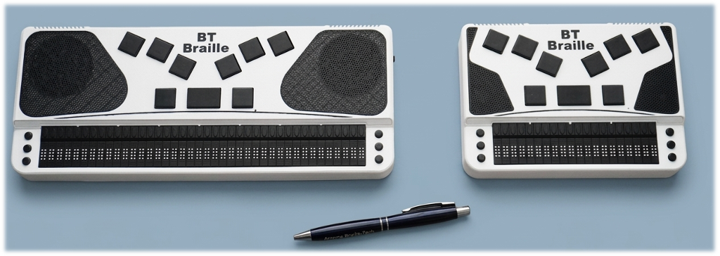 BT Braille 40 and BT Braille 20 on a blue surface with a ball point pen shown for scale. The ball point pen length is nearly equivalent to the length of BT Braille 20.