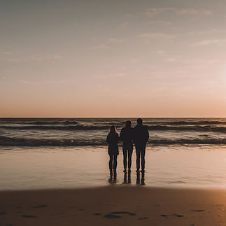 3 people standing near the water at the beach at sunset.jpg