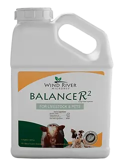 a white container labeled Wind River Microbes Balancer 2