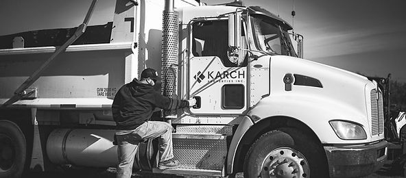 Karch Industries' dump truck preparing to load freshly cleared snow, highlighting our efficient snow removal and hauling services for Edmonton's winter season