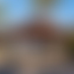 Entrance pavilion at North Shore Lookout Maui with tropical landscaping and open-air seating