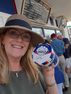 Tammie smiling and holding a pint of Handel’s Graham Central Station ice cream outside the shop.