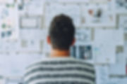 Man looking at board with ideas on paper