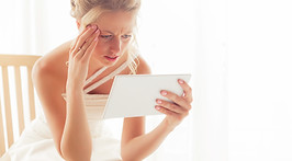Worried bride looking at tablet .jpg