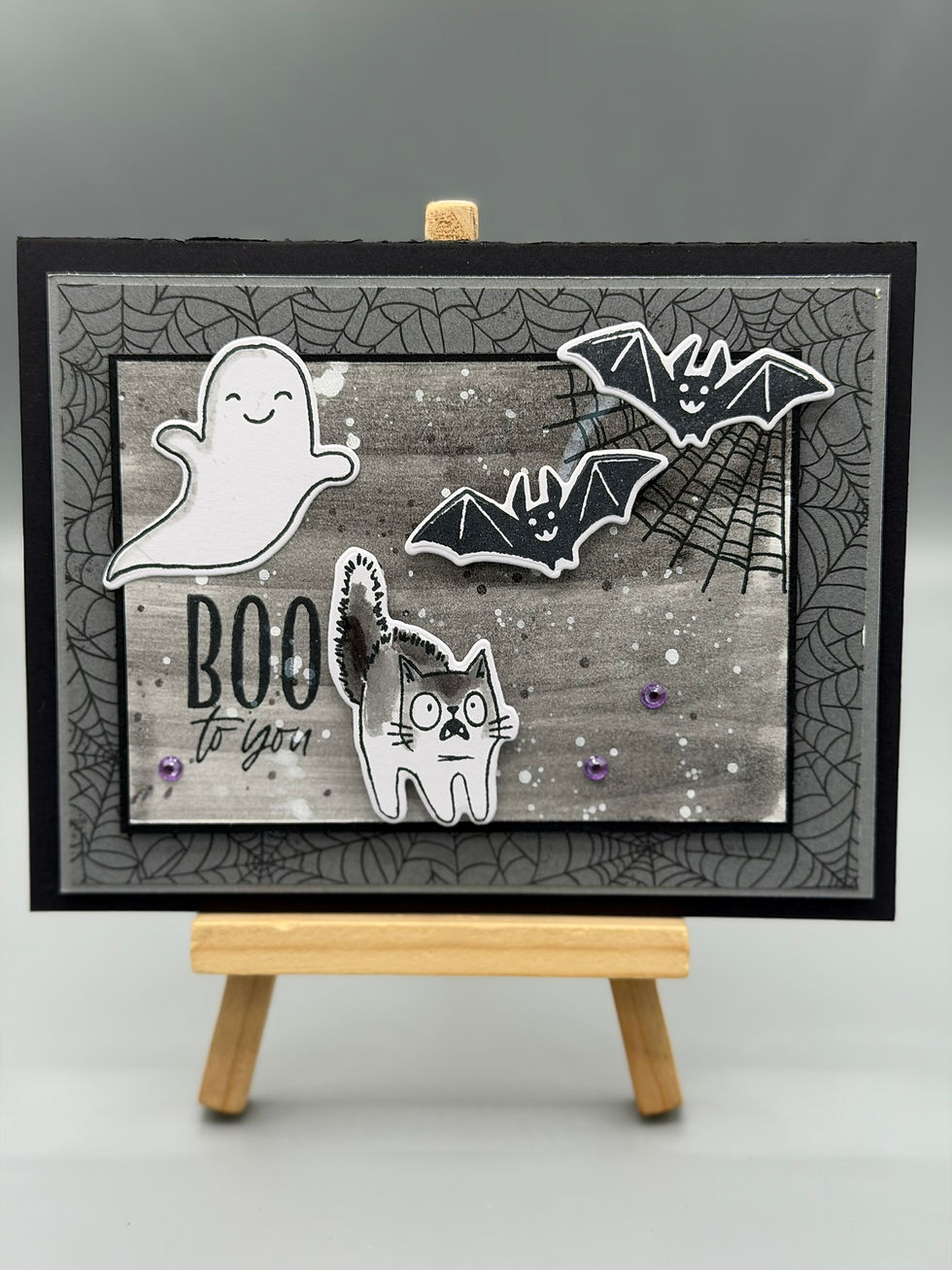 “Handmade Halloween card featuring ghost, bats, and scared cat with spiderweb background and ‘Boo to You’ text.”
