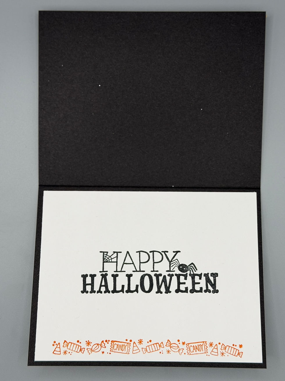 Thumbnail: “Handmade Halloween card featuring dogs in ghost costumes holding jack-o’-lanterns with spiderweb background and ‘Trick-or-Tr