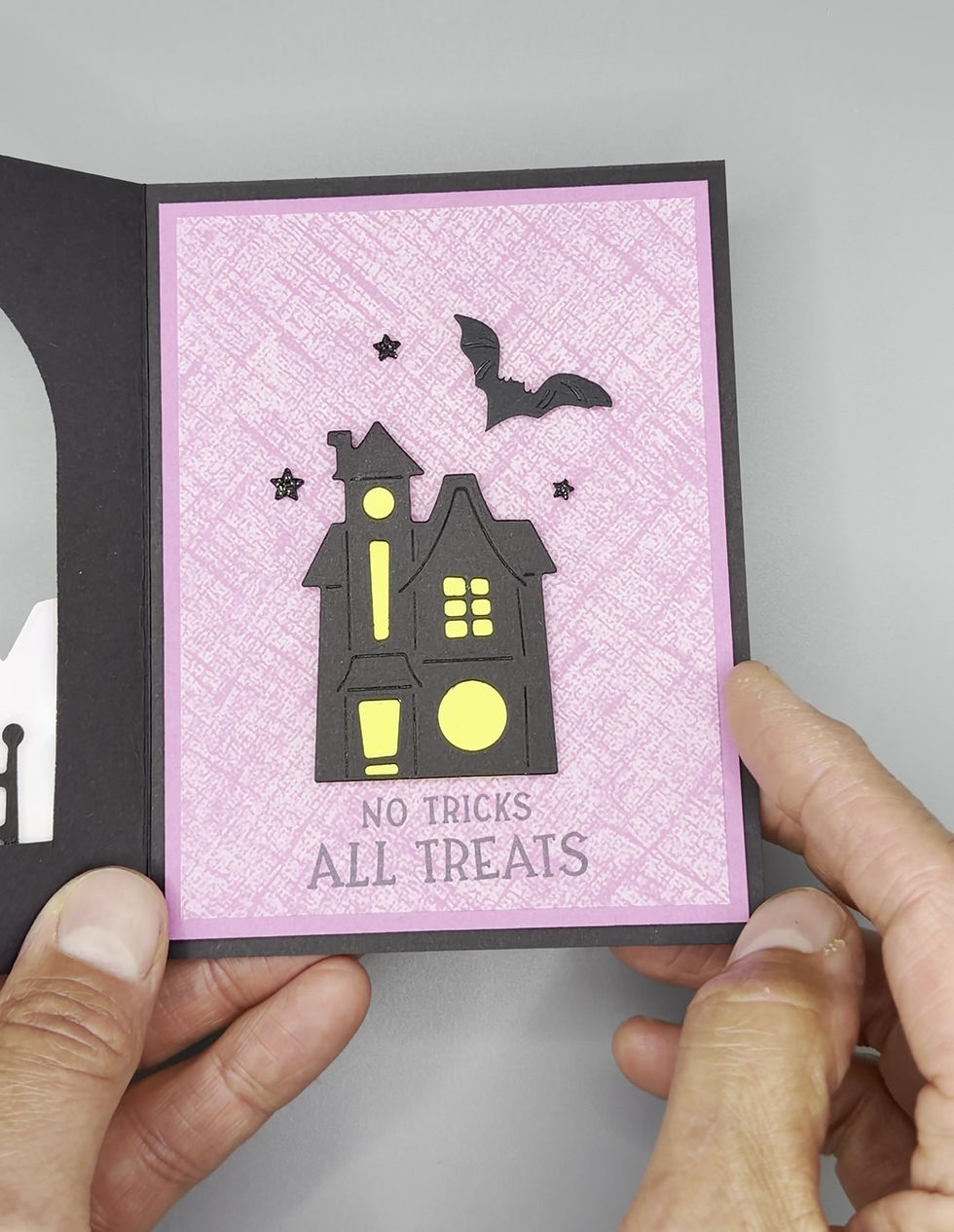 Thumbnail: “Handmade Halloween card featuring haunted house, bat, and trick-or-treat characters with ‘Boo’ lettering and festive candy b