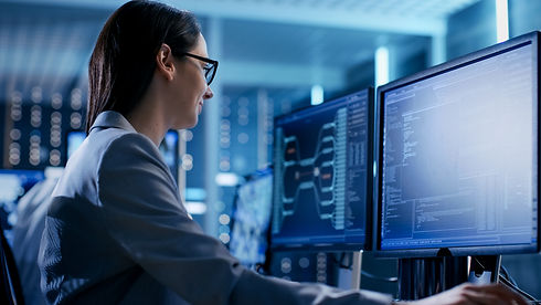 Close-up Shot of Female IT Engineer Working in Monitoring Room. She Works with Multiple Di