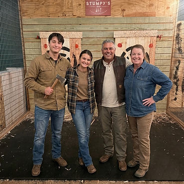Family pic of owners, Bryan & Kim, their son and daughter. AI editing to put each family member in denim, flannel and leather boots to fit the theme of Stumpy's.