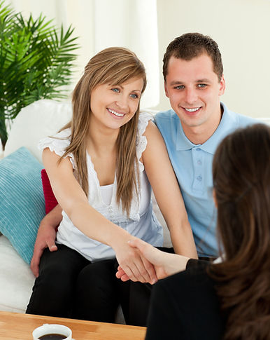 happy-couple-concluding-contract-with-female-dealer.jpg
