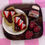 Thumbnail: fridge magnet of wooden cutting board with a plate of strawberry slices and nutella chocolate sandwich with a jar of nutella
