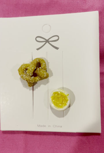 Thumbnail: pins of a salted pretzel and a beer cheese or mustard dipping sauce in a white bowl