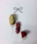 pins of italian bread and salami slices and slices of babybel red and yellow cheese