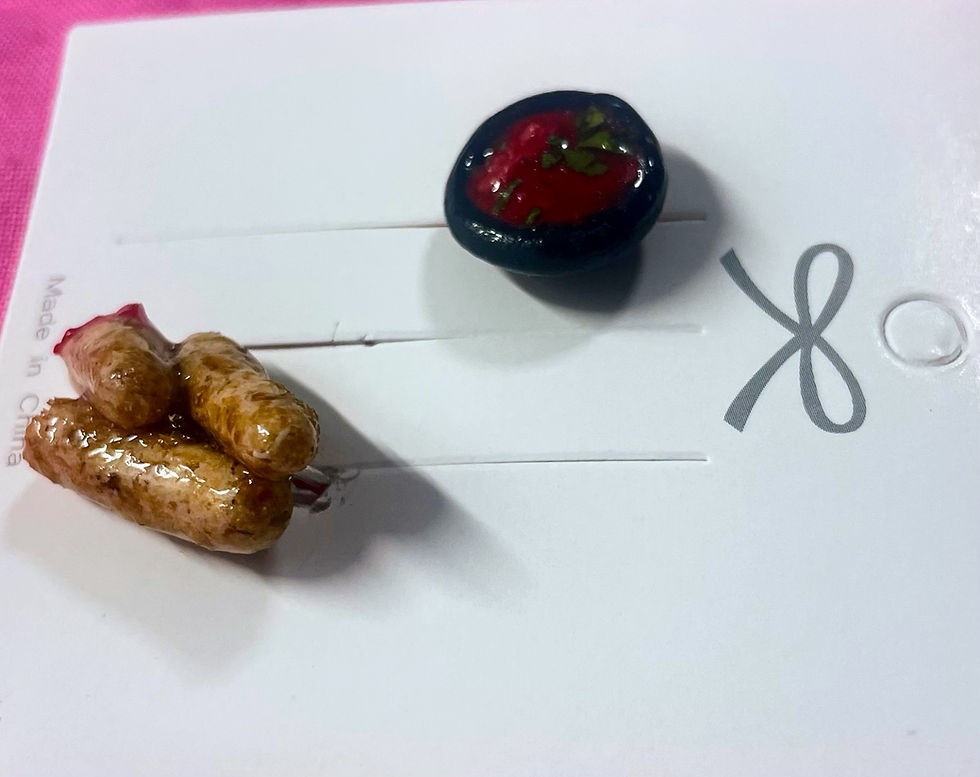 Thumbnail: lapel pins of 3 mozzarella sticks , one half eaten and dipped in marina sauce and a pin of marinara sauce in a black dish