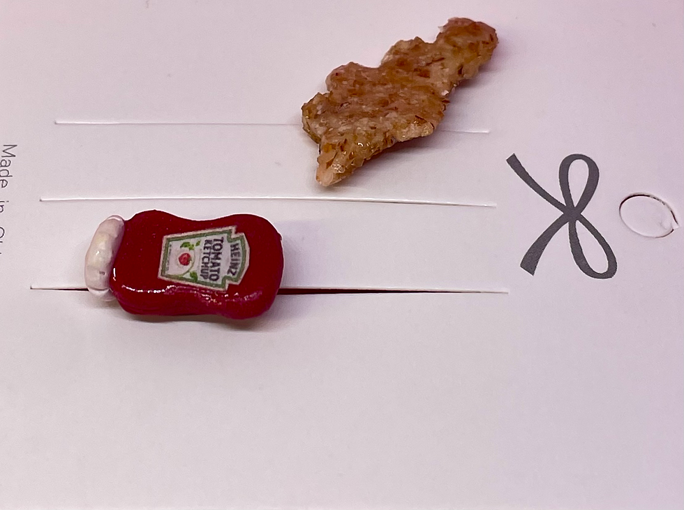 Thumbnail: Pin of a dinosaur chicken nugget and a pin of a heinz bottle of ketchup