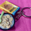 Thumbnail: keychain of a cheerios cereal box and a bowl of cereal with a colorful spoon  in it